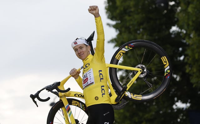 Cycling - Tour de France - Stage 21 - Mantes-la-Ville to Paris - Paris, France - July 27, 2025 UAE Team Emirates XRG's Tadej Pogacar celebrates on the podium with his bike while wearing the yellow jersey after winning the Tour de France REUTERS/Benoit Tessier/File Photo