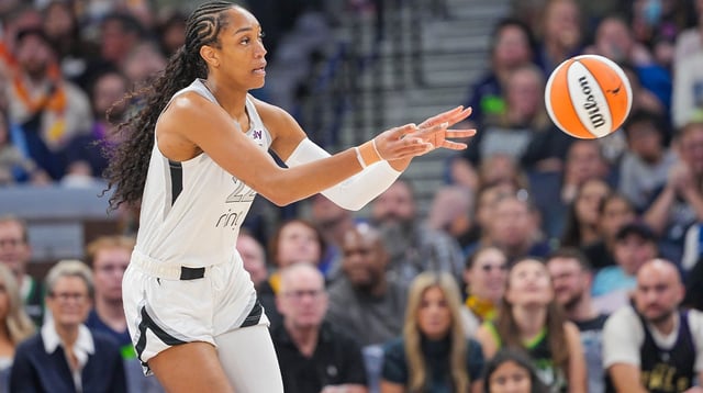 Jul 25, 2025; Minneapolis, Minnesota, USA; Las Vegas Aces center A&#39;ja Wilson (22) passes against the Minnesota Lynx in the first quarter at Target Center. Mandatory Credit: Brad Rempel-Imagn Images