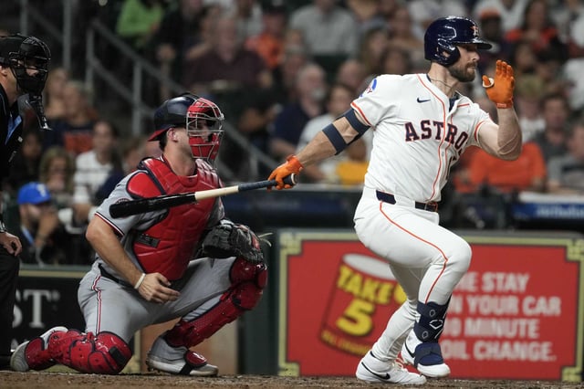 Houston Astros pinch hitter Cooper Hummel (16) hits after an RBI single off Washington Nationals relief pitcher Andry Lara during the fifth inning of an MLB baseball game in Houston, Tuesday, July 29, 2025.