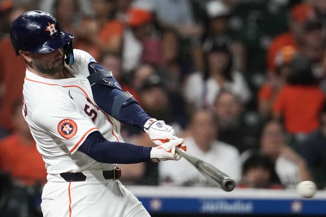 Houston Astros Christian Walker (8) hits a 2-RBI single during the seventh inning of an MLB baseball game in Houston, Tuesday, July 29, 2025.