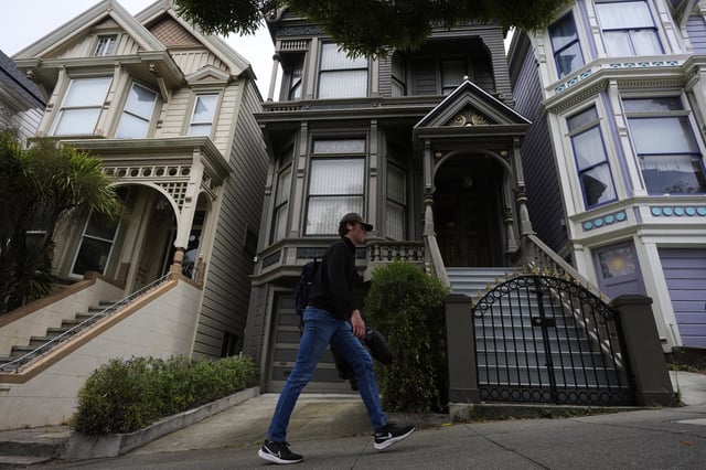 A man walks past the house where the original members of the Grateful Dead music group lived in San Francisco, Saturday, July 19, 2025. (AP Photo/Godofredo A. Vasquez)