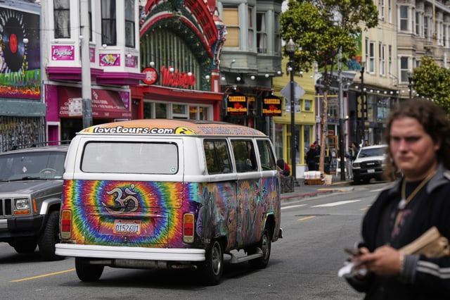 A tour van featuring a painting of musician Jerry Garcia travels through Haight Street in San Francisco, Saturday, July 19, 2025. (AP Photo/Godofredo A. Vasquez)