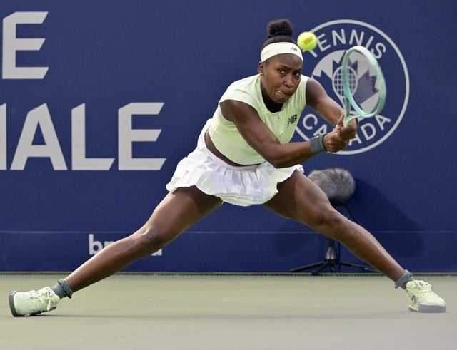 Jul 29, 2025; Montreal, QC, Canada; Coco Gauff (USA) returns the ball against Danielle Collins (USA) in second round play at IGA Stadium. Mandatory Credit: Eric Bolte-Imagn Images