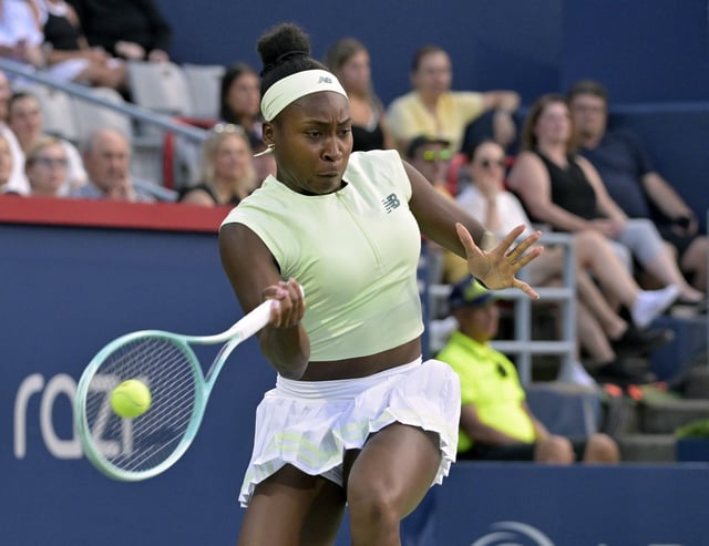 Jul 29, 2025; Montreal, QC, Canada; Coco Gauff (USA) returns the ball against Danielle Collins (USA) in second round play at IGA Stadium. Mandatory Credit: Eric Bolte-Imagn Images