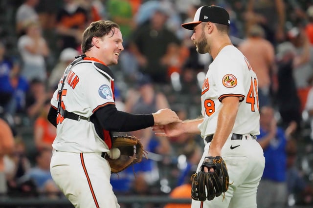 Jul 29, 2025; Baltimore, Maryland, USA; Baltimore Orioles catcher Adley Rutschman (35) greets pitcher Corbin Martin (48) after he pitched the ninth inning to earn the save against the Toronto Blue Jays at Oriole Park at Camden Yards. Mandatory Credit: Mitch Stringer-Imagn Images