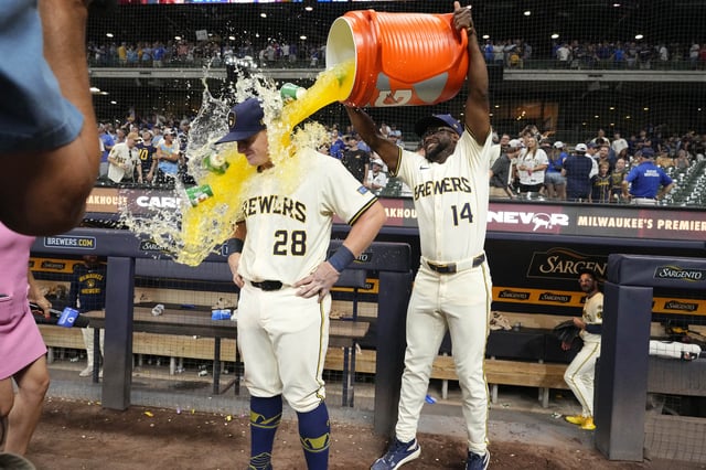 Jul 29, 2025; Milwaukee, Wisconsin, USA; Milwaukee Brewers shortstop Andruw Monasterio (14) dumps Gatorade over Milwaukee Brewers first base Andrew Vaughn (28) head after the game in which Milwaukee  Andrew Vaughn (28) hit a grand slam against the Chicago Cubs at American Family Field. Mandatory Credit: Michael McLoone-Imagn Images