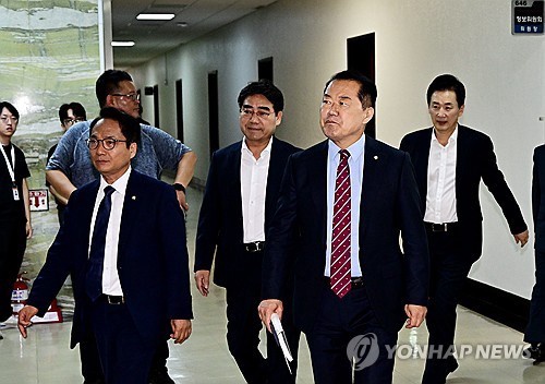 Members of the National Assembly's intelligence committee enter a room for a closed-door briefing by the National Intelligence Service on recent developments related to North Korea, in Seoul on July 30, 2025. (Yonhap)