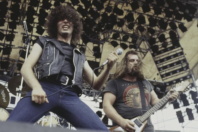 Vocalist Paul Mario Day and guitarist Kenny Cox of heavy metal group More perform at the Monsters of Rock festival at Donington Park in 1981.   