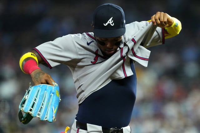 KANSAS CITY, MISSOURI - JULY 29: Ronald Acuña Jr. #13 of the Atlanta Braves pulls on his jersey as he leaves the game in the sixth inning against the Kansas City Royals at Kauffman Stadium on July 29, 2025 in Kansas City, Missouri.