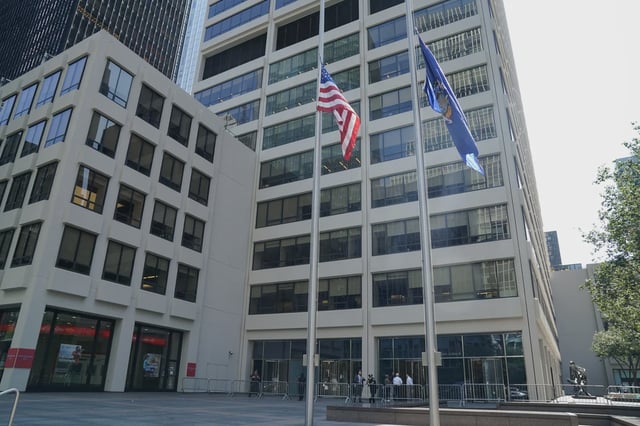 Flags fly at half-staff outside 345 Park Ave., the scene of the July 28th Midtown mass shooting, on July 29, 2025.