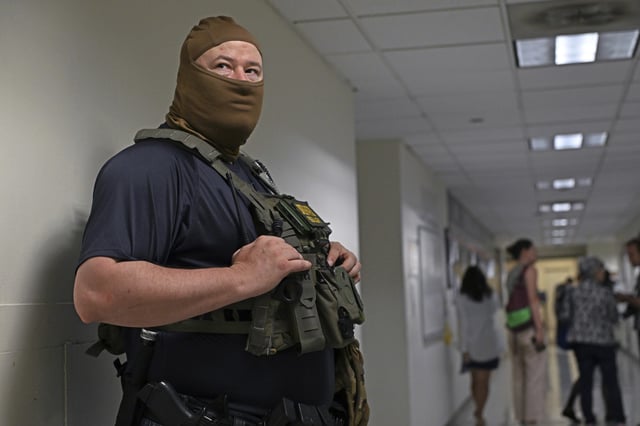 Federal agent outside the Immigration Courtrooms of Federal Plaza in New York.