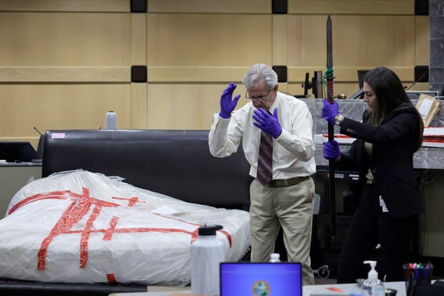 Crime Scene Investigations and Reconstruction witness Thomas S. Hill explains to the jury how he reenacted the crime scene and killing of as prosecutor Jaclyn Broudy holds the the bloodstained spear used to kill Silvia Garza in 2019. This during Adam Crespo’s trial on a charge of murder without premeditation at the Broward County Courthouse in Fort Lauderdale on Monday, July 28, 2025. Crespo is accused of killing his girlfriend, Garza, during an argument.  (Mike Stocker/South Florida Sun Sentinel)