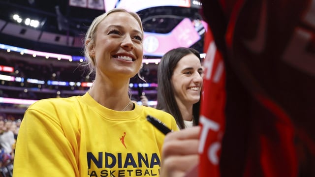 Jul 27, 2025; Chicago, Illinois, USA; Indiana Fever guards Sophie Cunningham (8) and Caitlin Clark (22)sign autographs before a WNBA game against the Chicago Sky at United Center. Mandatory Credit: Kamil Krzaczynski-Imagn Images