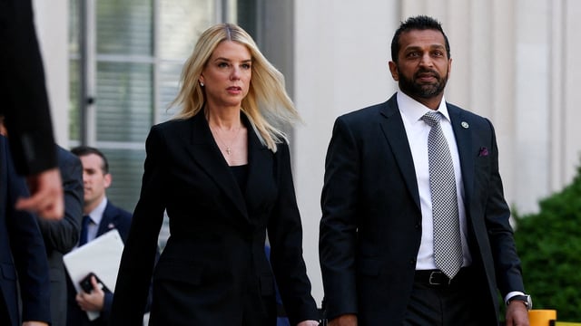 Attorney General Pam Bondi and FBI Director Kash Patel walk to attend a press conference to make an announcement 