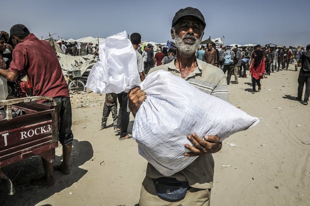 Palestinians collect food aid from the U.S.-backed Gaza Humanitarian Foundation in Rafah.