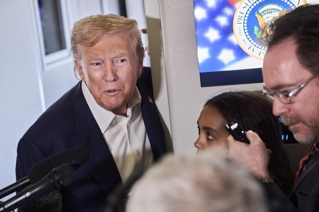 President Donald Trump speaks with reporters aboard Air Force One after leaving Aberdeen, Scotland, Tuesday, July 29, 2025, en route to Washington.