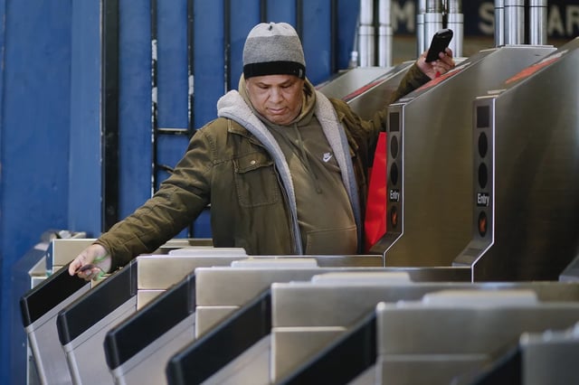A man walks through Times Square Subway Station in December 2022.