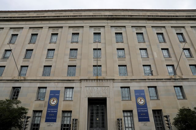 Signage is seen at the headquarters of the United States Department of Justice (DOJ) in Washington, D.C., U.S., May 10, 2021. REUTERS/Andrew Kelly/File Photo