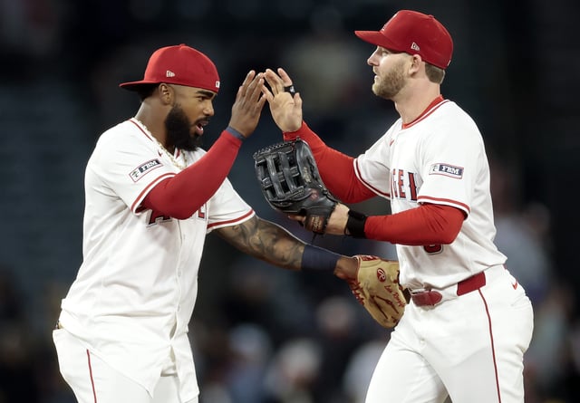 ANAHEIM, CALIFORNIA - JULY 28: Luis Rengifo #2 and Taylor Ward #3 of the Los Angeles Angels celebrate a 6-4 win against the Texas Rangers at Angel Stadium of Anaheim on July 28, 2025 in Anaheim, California.