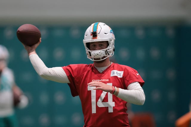Jul 23, 2025; Miami Gardens, FL, USA; Miami Dolphins quarterback Quinn Ewers (14) throws the football during training camp at Baptist Health Training Complex. Mandatory Credit: Sam Navarro-Imagn Images/ File Photo