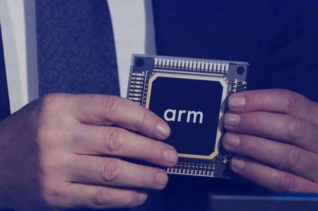 Rene Haas, CEO of chip tech provider Arm Holdings, holds a replica of a chip with his company's logo on it, during an event in which Malaysia's Prime Minister Anwar Ibrahim officially announces a $250 million deal with the company, in Kuala Lumpur, Malaysia March 5, 2025. REUTERS/Hasnoor Hussain/File Photo
