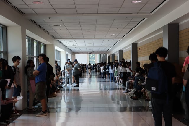 The line for the CNE job fair looped down a long hallway beside the event hall. 