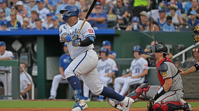Jul 28, 2025; Kansas City, Missouri, USA; Kansas City Royals catcher Salvador Perez (13) singles in a run in the first inning against the Atlanta Braves at Kauffman Stadium. Mandatory Credit: Peter Aiken-Imagn Images