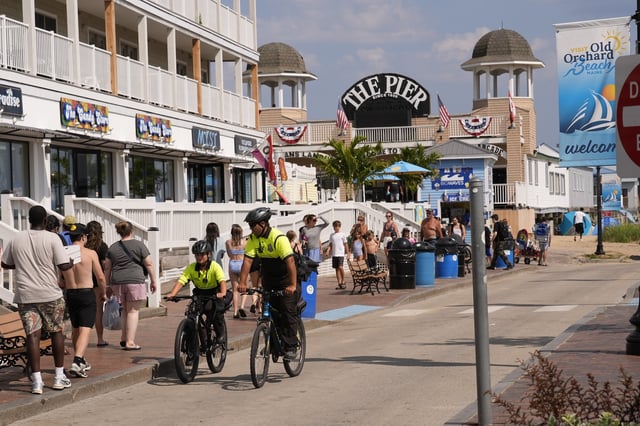 Community Service Officers from the Old Orchard Beach Police Dept. patrol on bicycles, Tuesday, July 29, 2025, in Old Orchard Beach, Maine. (AP Photo/Robert F. Bukaty)