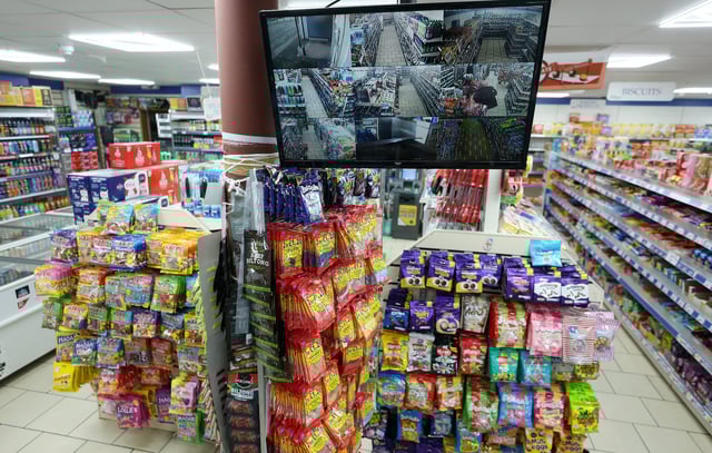 A monitor showing CCTV cameras is seen inside a general store in Liverpool, Britain, January 30, 2025. REUTERS/Phil Noble/File Photo