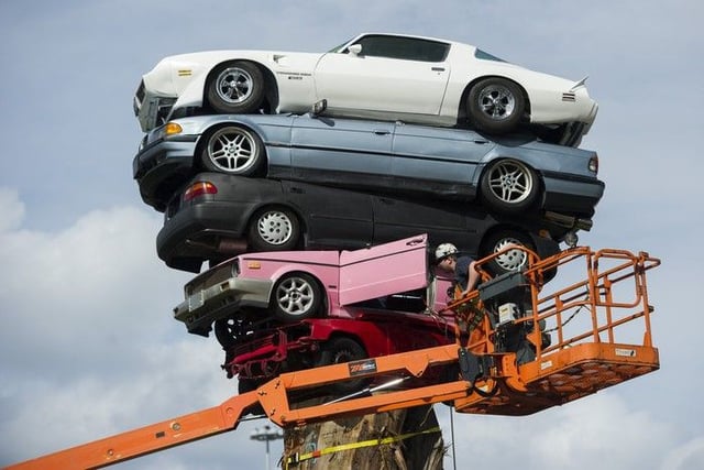 Workers finish the installation of Marcus Bowcott's Trans Am Totem on March 31 2015.