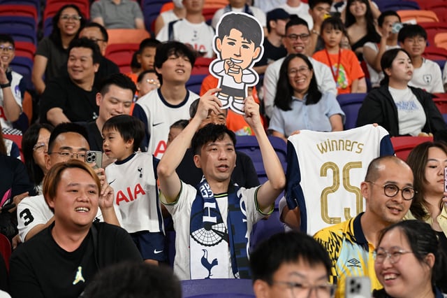 Tottenham supporters cheer during Tuesday's training session.