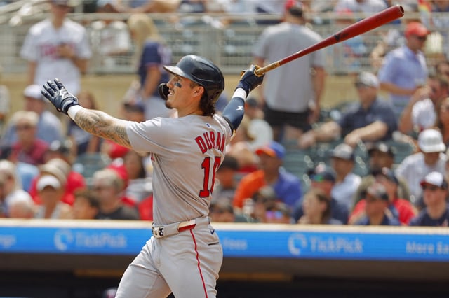 Jul 30, 2025; Minneapolis, Minnesota, USA; Boston Red Sox center fielder Jarren Duran (16) hits a two run home run against the Minnesota Twins in the sixth inning at Target Field. Mandatory Credit: Bruce Kluckhohn-Imagn Images