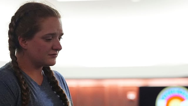 Miriam Meservy returns to her seat after making a statement after her father, dentist James Craig, had a verdict rendered in his murder trial in the district court in Arapahoe County, Colorado.