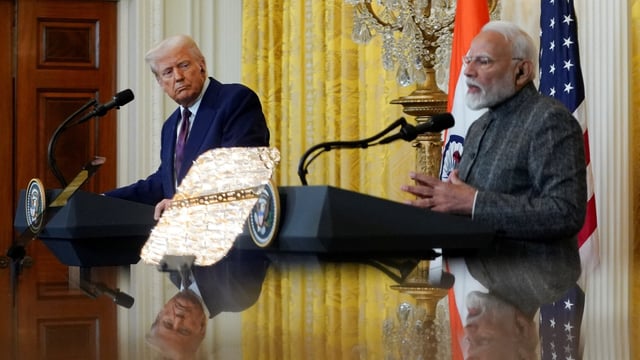 U.S. President Donald Trump and Indian Prime Minister Narendra Modi are pictured in a mirror as they attend a joint press conference at the White House in Washington, D.C., U.S., February 13, 2025. 