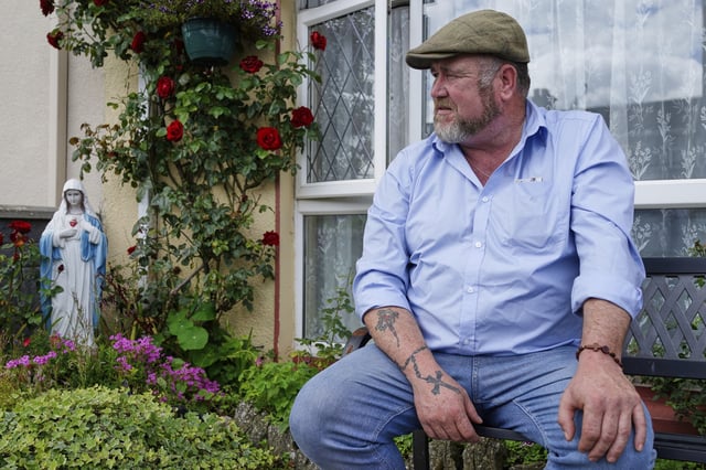 Patrick McDonagh, who grew up in the neighborhood built atop the former mother and baby home in Tuam, Ireland, sits outside his family's home on Tuesday, July 8, 2025. (AP Photo/Brian Melley)