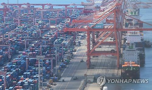 Containers are stacked at a port in the South Korean city of Busan on July 31, 2025. (Yonhap)