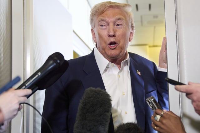 President Donald Trump speaks with reporters aboard Air Force One after leaving Aberdeen, Scotland, Tuesday, July 29, 2025, en route to Washington.
