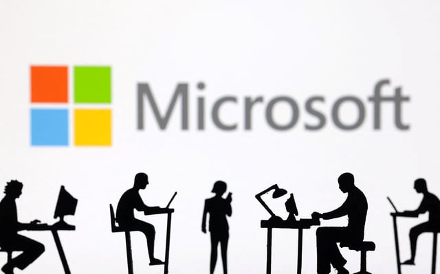 Figurines with computers and smartphones are seen in front of Microsoft Corporation logo in this illustration taken, February 19, 2024. REUTERS/Dado Ruvic/Illustration/File Photo