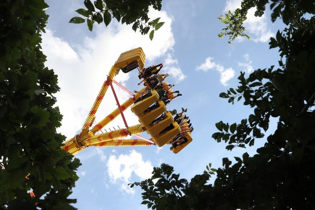 A carnival ride swings people like a pendulum at Fiesta del Sol on West Cermak Road in the Pilsen neighborhood on July 28, 2022, in Chicago. The festival of amusement rides, food, and music runs Thursday through Sunday. (John J. Kim/Chicago Tribune)