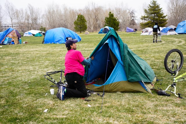 James Anderson, 53, braces his tent against a coming snowstorm in Fort Collins, Colorado, while staying in an encampment at a shelter for people experiencing homelessness.