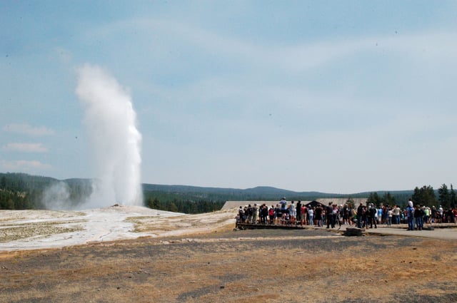 Old Faithful erupts as visitors watch on Aug. 4, 2018, in Yellowstone National Park. The geyser puts on its show about every 90 minutes.