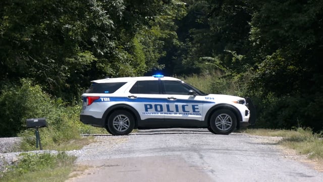 A police vehicle parks in Lake County, Tennessee, where the bodies were found
