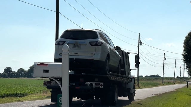 A car is removed from near where the bodies were found in Lake County, Tennesee.