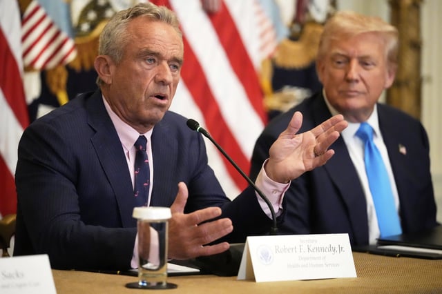 Health and Human Services Secretary Robert F. Kennedy Jr. speaks as President Donald Trump listens at an event to promote his proposal to improve Americans' access to their medical records in the East Room of the White House, Wednesday, July 30, 2025, in Washington. (AP Photo/Mark Schiefelbein)