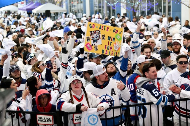 Winnipeg Jets fans attend a street party prior to game 2 of the NHL hockey Stanley Cup first-round playoff series against the Colorado Avalanche in Winnipeg, Tuesday, April 23, 2024. THE CANADIAN PRESS/Fred Greenslade