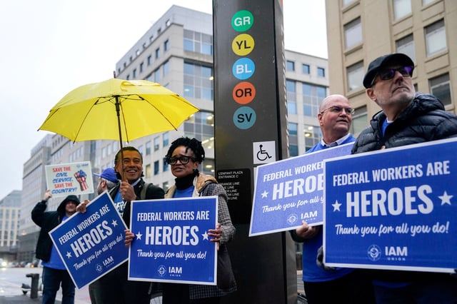 Labor union members hold placards on the day of a rally in support of federal workers during a rush hour protest outside the L'Enfant Plaza Metro Station in Washington, D.C., U.S., March 24, 2025. REUTERS/Kent Nishimura/File Photo