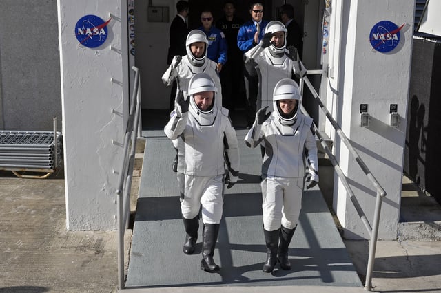 Astronauts, front row from left, Mike Fincke, of NASA, and Zena Cardman, of NASA, back row from left, Oleg Platonov, of Russia and Kimiya Yui, of Japan waves as they leave the Operations and Checkout Building for a trip the Kennedy Space Center's Launch Pad 39-A and a planned liftoff on a SpaceX Falcon 9 rocket Thursday, July 31, 2025, in Cape Canaveral , Fla. (AP Photo/John Raoux)