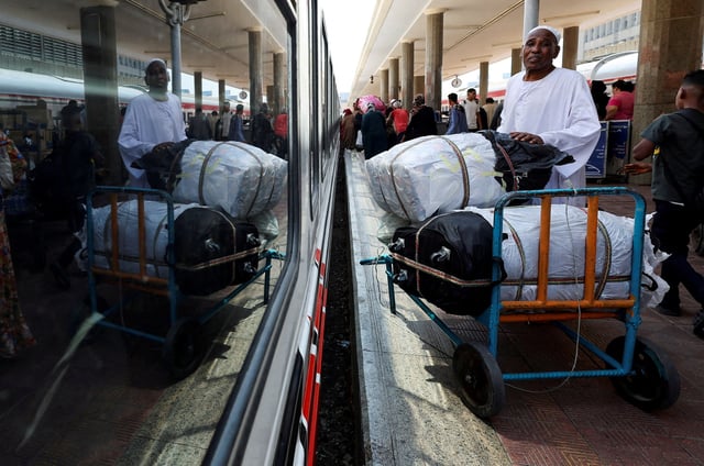 A Sudanese man waits next to his luggage, as families displaced by conflict between the Sudanese Armed Forces and the Rapid Support Forces (RSF) crowd at Cairo’s main station to board a free train with a voluntary return coordinated by the Egyptian government to Aswan, where buses will take them back to their homes in Khartoum, in Cairo, Egypt July 28, 2025. REUTERS/Amr Abdallah Dalsh/File Photo