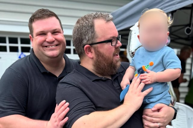 Logan Riley, left, with Brandon Keith Riley-Mitchell and the couple&#39;s 1-year-old son, Atticus.