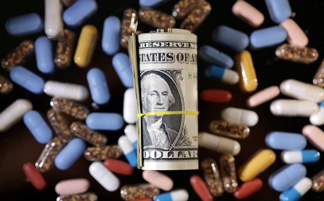 U.S. dollar banknotes and medicines are seen in this illustration taken, June 27, 2024. REUTERS/Dado Ruvic/Illustration/File Photo